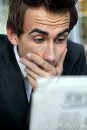 businessman-reading-bad-news-newspaper-10860218